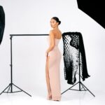 Glamorous studio shot of a woman in a strapless evening dress, exuding elegance and sophistication.